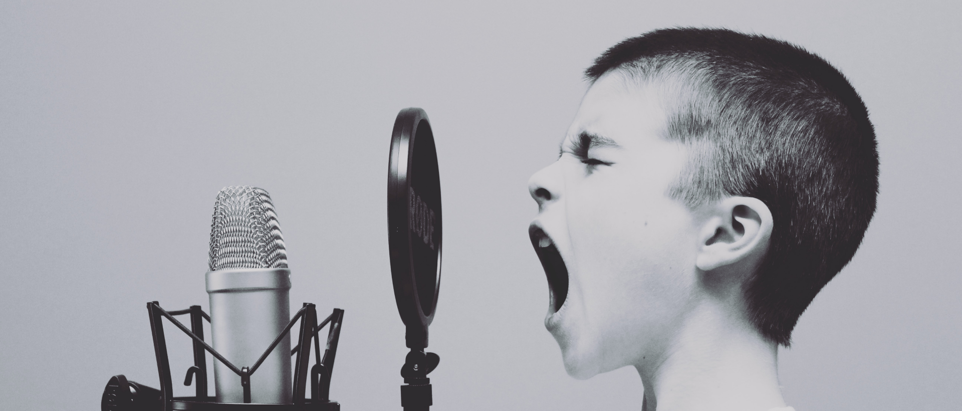 Kind schreit in Mikrofon - sinnbildlich für Voice User Interface - xeit